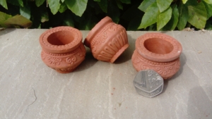 Small clay oil lamps shaped like cooking pots